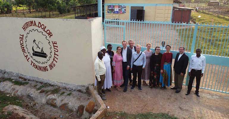 Mission partners at the Technical Training Institute gate